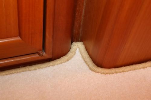 Whipping on a new carpet fitted to a Fleming 55 boat